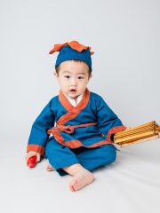 国产古装历史剧海报，宫殿建筑宏伟背景，主演身着华服，红色调庄重威严